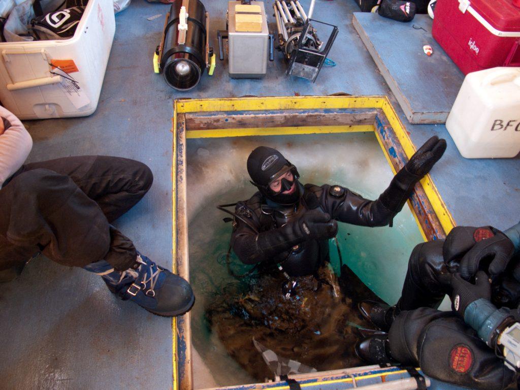 Doug Anderson discussing the dive plan before an under-ice dive. BBC Netflix Apple TV Wildlife Filming Filmmaking Underwater Natural History Ocean Cinematography Gates  Housings Nauticam REvo Rebreathers SCUBA Finistare clothing